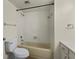 Standard bathroom featuring a tiled shower-tub, toilet, and neutral fixtures at 2072 Monterey Dr, Deltona, FL 32738