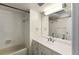 Bathroom with a standard tub, vanity, mirror, and neutral tiling throughout at 2072 Monterey Dr, Deltona, FL 32738