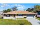 Charming single-story home featuring a brick facade, well-manicured lawn, and attached two-car garage at 2072 Monterey Dr, Deltona, FL 32738