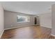 Spacious living room with laminate flooring and a large front window at 2072 Monterey Dr, Deltona, FL 32738
