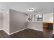 Open living area with wood-look floors and view of breakfast bar with decorative posts at 2072 Monterey Dr, Deltona, FL 32738