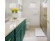 Bathroom featuring vanity with green cabinets and a glass-enclosed shower at 2320 Lelani Cir, Davenport, FL 33897