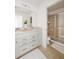 Bathroom featuring a double sink vanity with white cabinetry and a sliding glass shower door at 2320 Lelani Cir, Davenport, FL 33897
