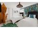 Stylish bedroom featuring two twin beds, jungle-themed wallpaper, and a large leaf-shaped rug at 2320 Lelani Cir, Davenport, FL 33897