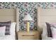 Cozy bedroom detail with floral wallpaper and stylish bedside lamp at 2320 Lelani Cir, Davenport, FL 33897