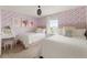 Charming bedroom featuring two beds and vibrant wallpaper at 2320 Lelani Cir, Davenport, FL 33897