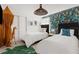 Stylish bedroom featuring two twin beds, jungle-themed wallpaper, and a large leaf-shaped rug at 2320 Lelani Cir, Davenport, FL 33897