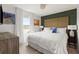 Well-lit bedroom with dark green accent wall and large window view at 2320 Lelani Cir, Davenport, FL 33897