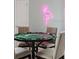 Entertainment space featuring a poker table, comfortable chairs, and a flamingo neon wall decoration at 2320 Lelani Cir, Davenport, FL 33897