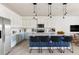 Modern kitchen featuring an island with seating, stainless steel appliances, and sleek countertops at 2320 Lelani Cir, Davenport, FL 33897