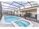 The pool and spa are enclosed by a fence and a screened in lanai at 2320 Lelani Cir, Davenport, FL 33897