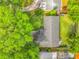 The aerial view shows a home with mature trees, a fenced backyard, and a screened-in pool area at 2405 Dellwood Dr, Orlando, FL 32806