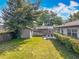 This aerial view shows a home with fenced backyard, a shed, a dining set, and screened-in pool area at 2405 Dellwood Dr, Orlando, FL 32806