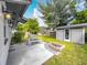 A backyard patio features a fire pit, dining furniture, and a detached storage shed for outdoor living and entertaining at 2405 Dellwood Dr, Orlando, FL 32806