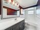 Bright bathroom with a sink, vanity, and tiled walls at 2405 Dellwood Dr, Orlando, FL 32806