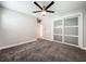 Inviting bedroom featuring a ceiling fan, soft gray walls, and a closet with sliding doors at 2405 Dellwood Dr, Orlando, FL 32806