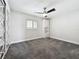 Bedroom with a ceiling fan, shuttered windows and carpet at 2405 Dellwood Dr, Orlando, FL 32806