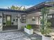 This home features a lush yard, gray brick walkway, and an attached carport at 2405 Dellwood Dr, Orlando, FL 32806