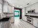 Well-lit kitchen with stainless steel appliances, white cabinets, and granite countertops at 2405 Dellwood Dr, Orlando, FL 32806