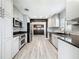 Bright kitchen featuring white cabinets, stainless appliances, and granite countertops at 2405 Dellwood Dr, Orlando, FL 32806