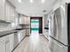 Bright kitchen with stainless steel appliances and white cabinets at 2405 Dellwood Dr, Orlando, FL 32806