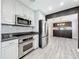 Modern kitchen with stainless steel appliances, granite countertops, and white cabinetry at 2405 Dellwood Dr, Orlando, FL 32806