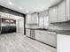 Modern kitchen featuring gray cabinets, stainless steel appliances, and tile backsplash at 2405 Dellwood Dr, Orlando, FL 32806