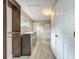 Bright laundry room features modern machines, stylish wood-look tile floors, built-in storage, and a convenient window at 2405 Dellwood Dr, Orlando, FL 32806
