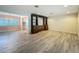 Open living space with wood-style tile floors and built-in wooden shelving at 2405 Dellwood Dr, Orlando, FL 32806