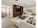 Bright living room featuring a large sectional sofa, built-in shelving, and an adjacent dining area at 2405 Dellwood Dr, Orlando, FL 32806
