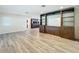 Spacious living room showcasing wood-look tile floors and custom built-in storage at 2405 Dellwood Dr, Orlando, FL 32806