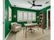 Stylish home office with green walls, modern lighting, ceiling fan, and comfortable workspace at 2405 Dellwood Dr, Orlando, FL 32806