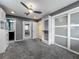 Spacious walk-in closet featuring custom shelving, drawers, a ceiling fan, and mirrored doors at 2405 Dellwood Dr, Orlando, FL 32806