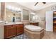 This bathroom boasts double vanities, a garden tub with a decorative tile surround, and a separate water closet at 2731 Cypress Tree Trl, St Cloud, FL 34772