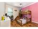 The bedroom boasts a sturdy wooden bunk bed, hardwood floors, and a whimsical ambiance at 2731 Cypress Tree Trl, St Cloud, FL 34772