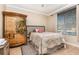 This bedroom features a quaint headboard and a unique armoire with an artistic palm tree design at 2731 Cypress Tree Trl, St Cloud, FL 34772