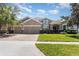 Charming two-story home with a well-manicured lawn, mature trees, and a three car garage at 2731 Cypress Tree Trl, St Cloud, FL 34772