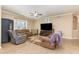 Open-concept living room with large windows, tiled floor, ceiling fan, and natural light at 2731 Cypress Tree Trl, St Cloud, FL 34772