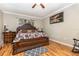 The main bedroom boasts traditional decor, a ceiling fan, and is filled with natural light at 2731 Cypress Tree Trl, St Cloud, FL 34772