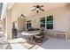 Spacious covered patio with a dining table, ceiling fans, and a view of the well maintained backyard at 2731 Cypress Tree Trl, St Cloud, FL 34772