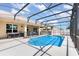 In-ground pool with screened enclosure, features an adjacent covered patio, perfect for outdoor gatherings at 2731 Cypress Tree Trl, St Cloud, FL 34772