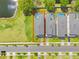 Aerial view showing a home and backyard with a private pool that backs to a pond and green space at 2775 Bookmark Dr, Kissimmee, FL 34746