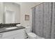 Neat bathroom featuring a white vanity with a dark countertop and shower and tub combo at 2775 Bookmark Dr, Kissimmee, FL 34746