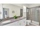 Modern bathroom with double sinks, a large mirror, and a glass-enclosed shower at 2775 Bookmark Dr, Kissimmee, FL 34746