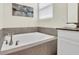 Elegant bathroom showcasing a deep soaking tub with tile surround and bronze fixtures at 2775 Bookmark Dr, Kissimmee, FL 34746
