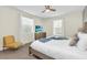 Bright bedroom featuring two windows, neutral walls, and a TV above a dresser at 2775 Bookmark Dr, Kissimmee, FL 34746