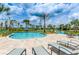 Relax by the community pool on comfortable lounge chairs with beautiful palm trees and blue skies at 2775 Bookmark Dr, Kissimmee, FL 34746
