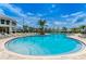 The community features a large, inviting pool surrounded by palm trees and comfortable lounge chairs at 2775 Bookmark Dr, Kissimmee, FL 34746