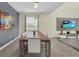 Dining area with large table, seating for eight, contemporary lighting, and an open layout at 2775 Bookmark Dr, Kissimmee, FL 34746