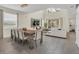 Open-concept with dining area, large table, and view to the living room and beyond at 2775 Bookmark Dr, Kissimmee, FL 34746